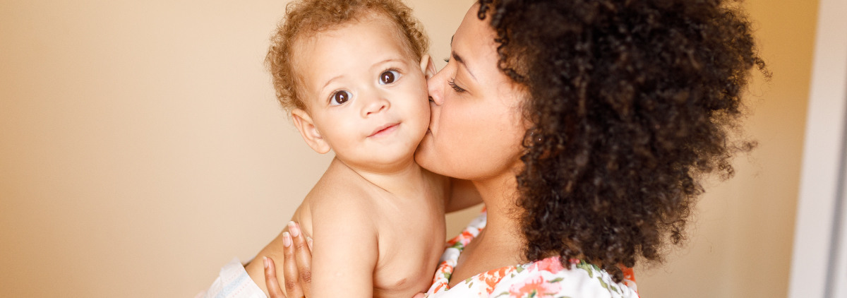 Latin mother cuddles her baby