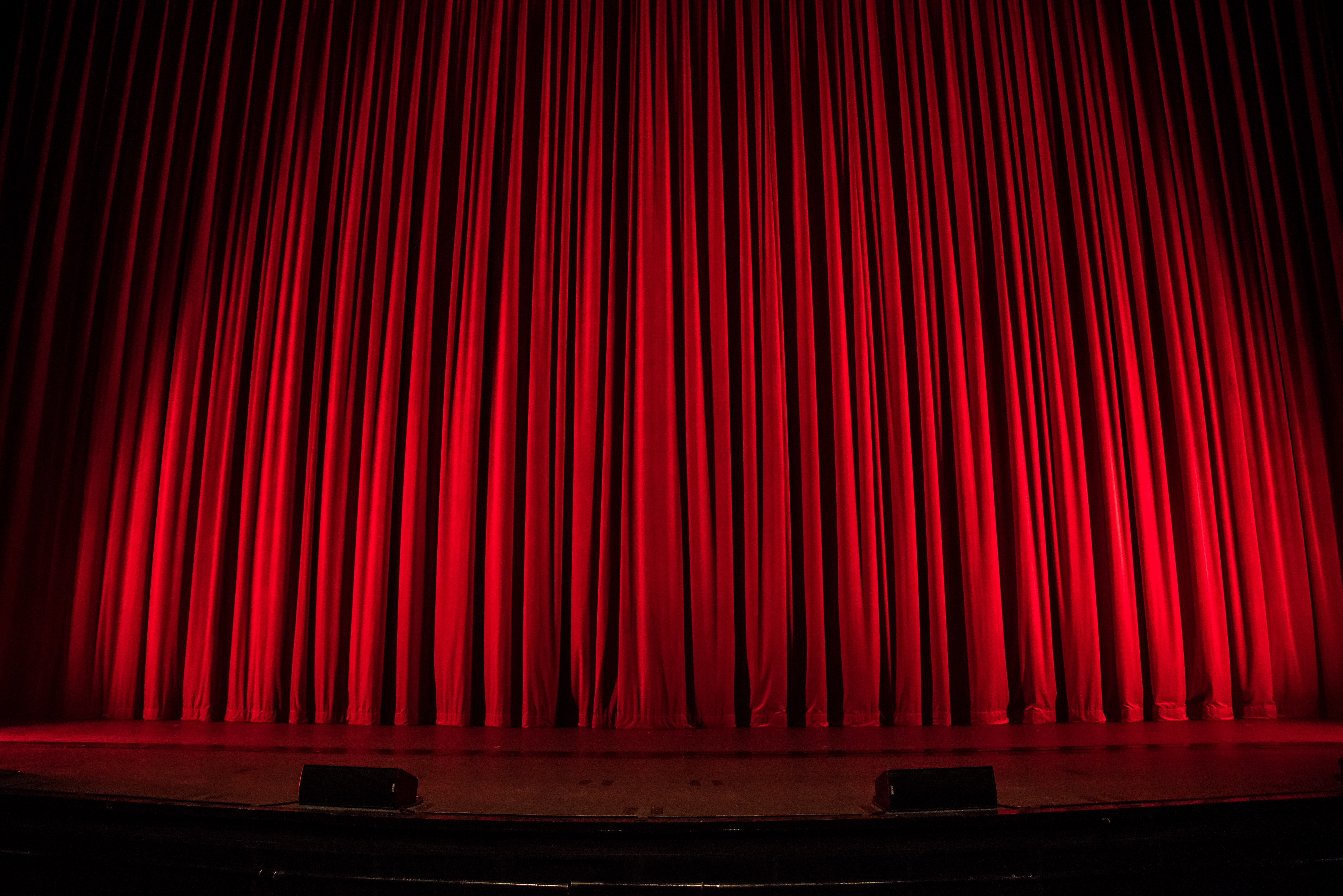 Closed red stage curtains.