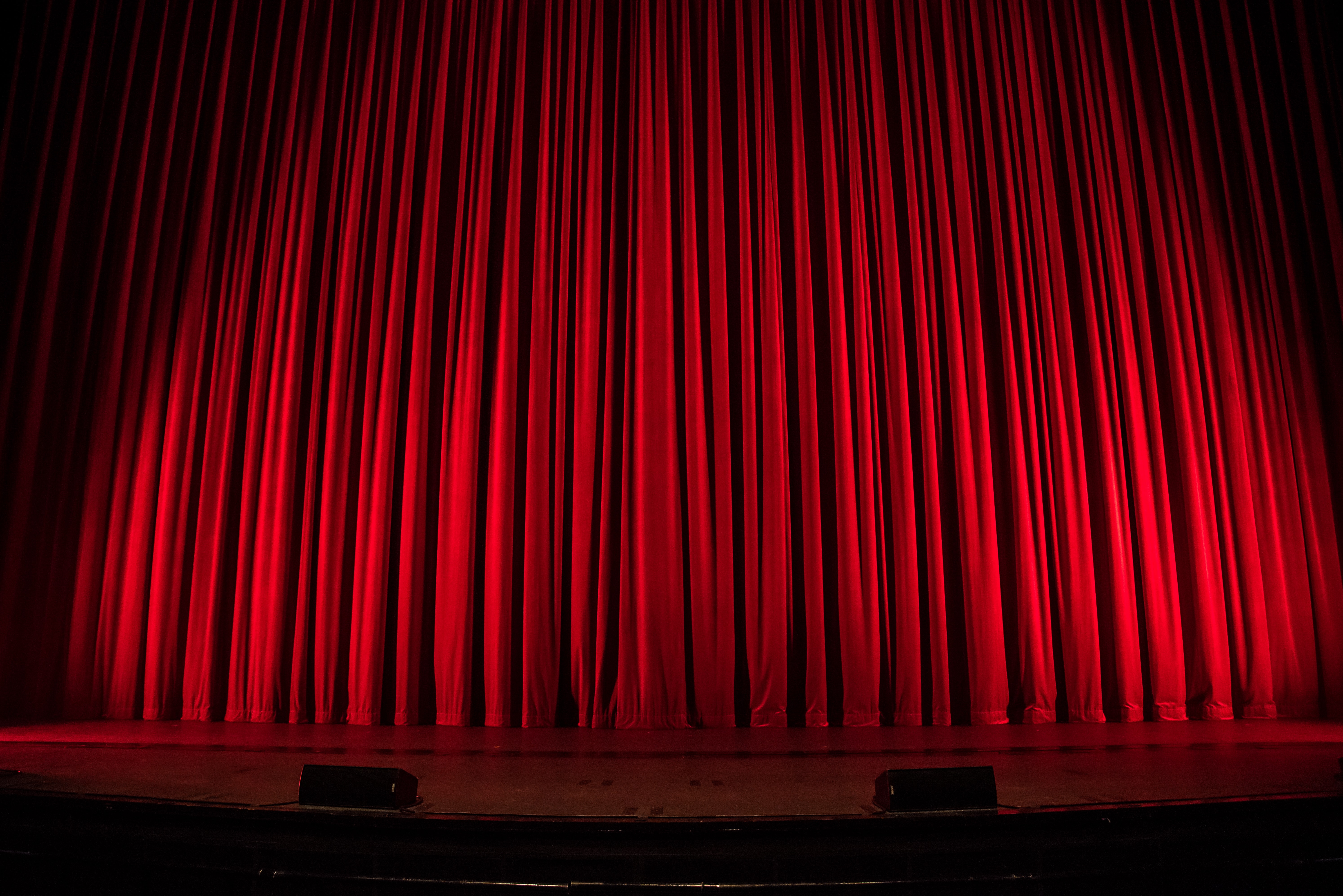 Closed red stage curtains.