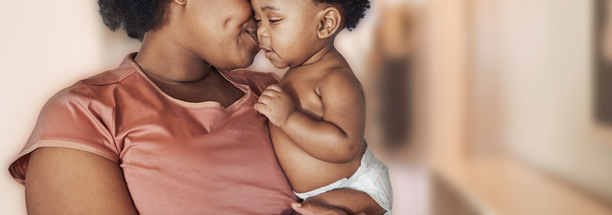 Black mother kissing his baby on the cheek