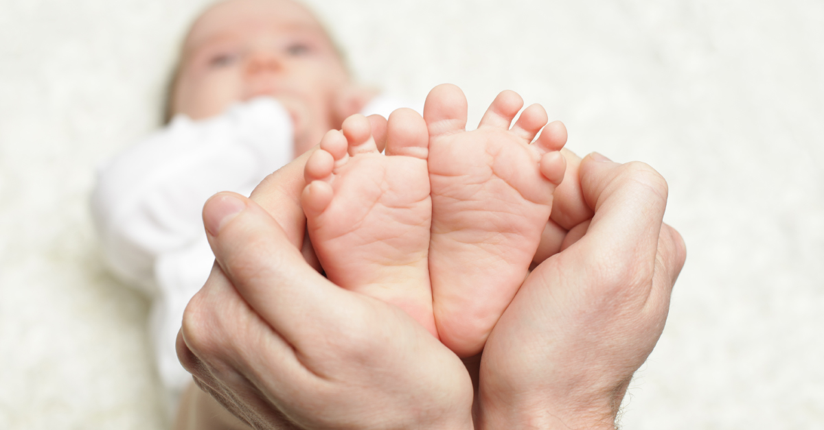 Hands holding baby's feet