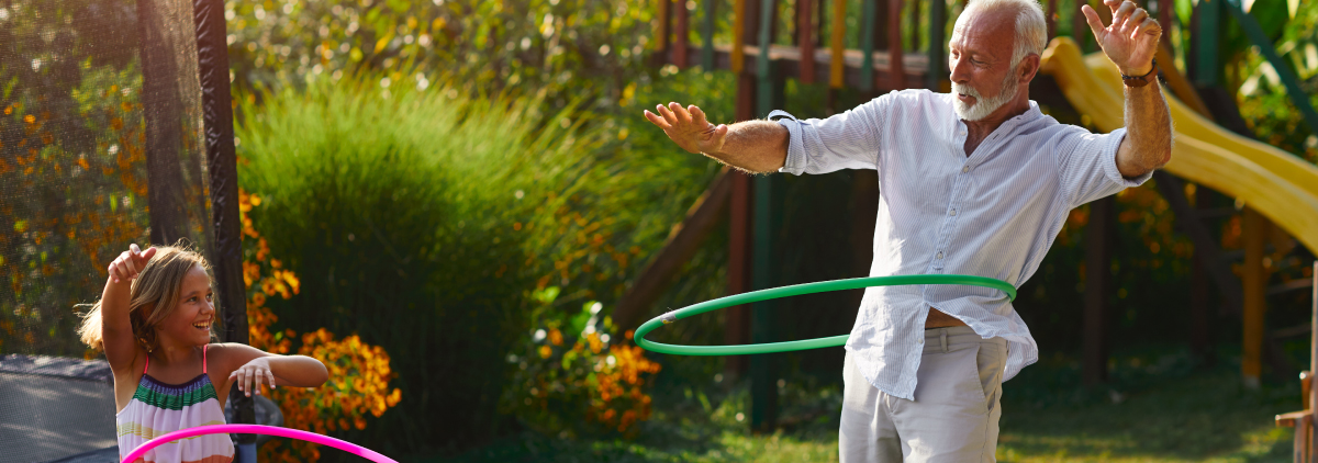 Grandfather and daughter hooping together outdoor