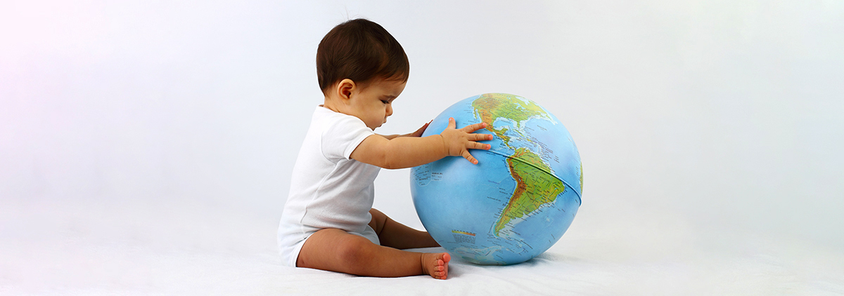 baby playing with earth-shaped ball