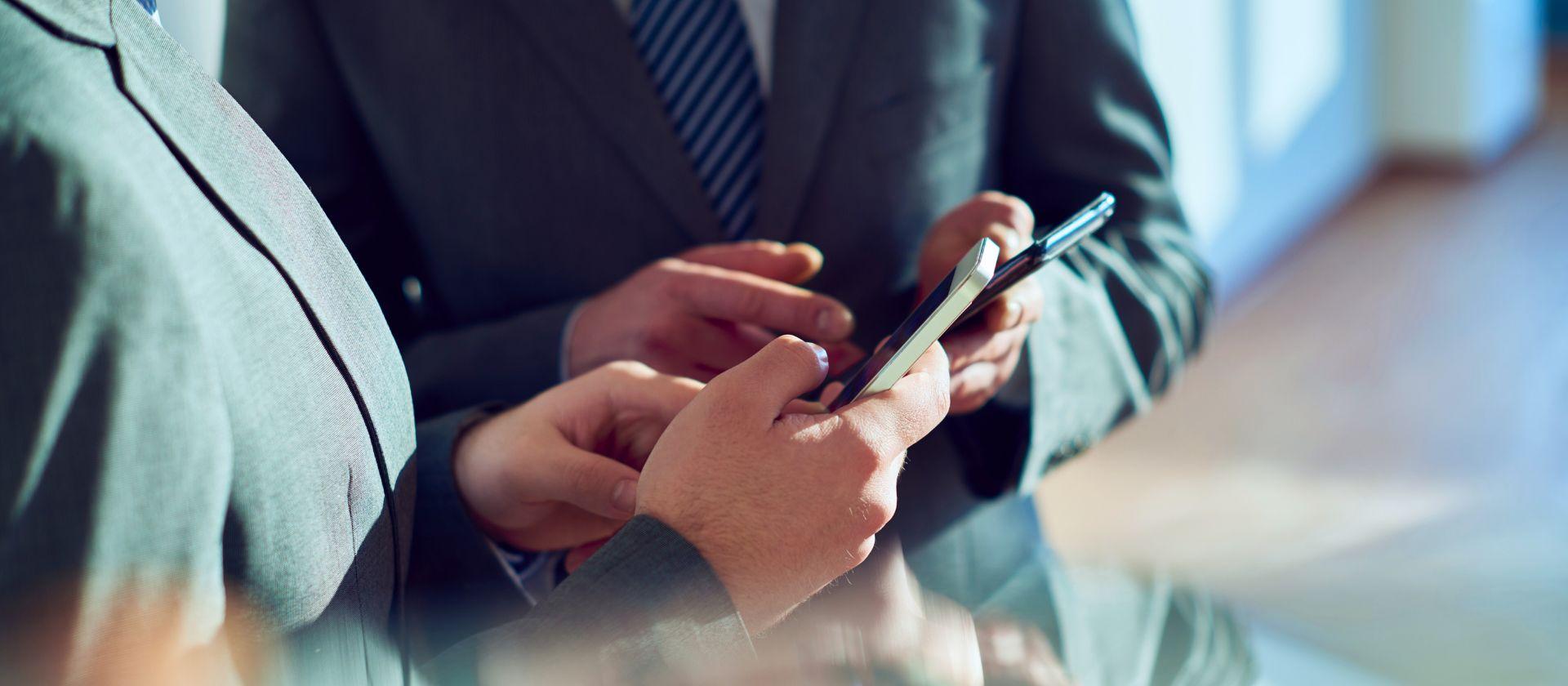 Two people using smartphones.