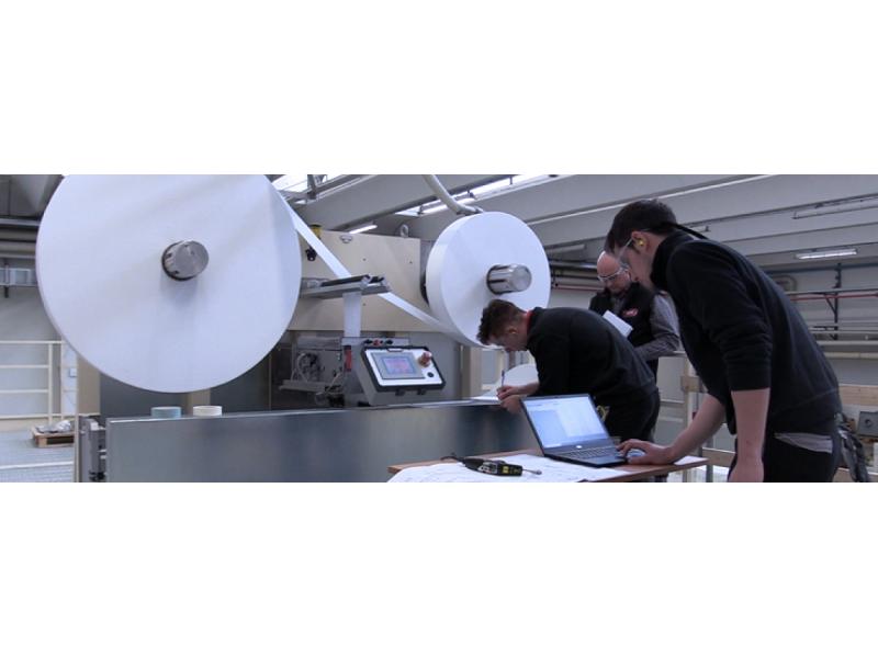 Auditors with laptops checking on a GDM machine