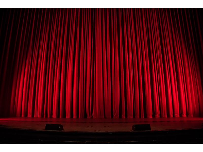 Closed red stage curtains.