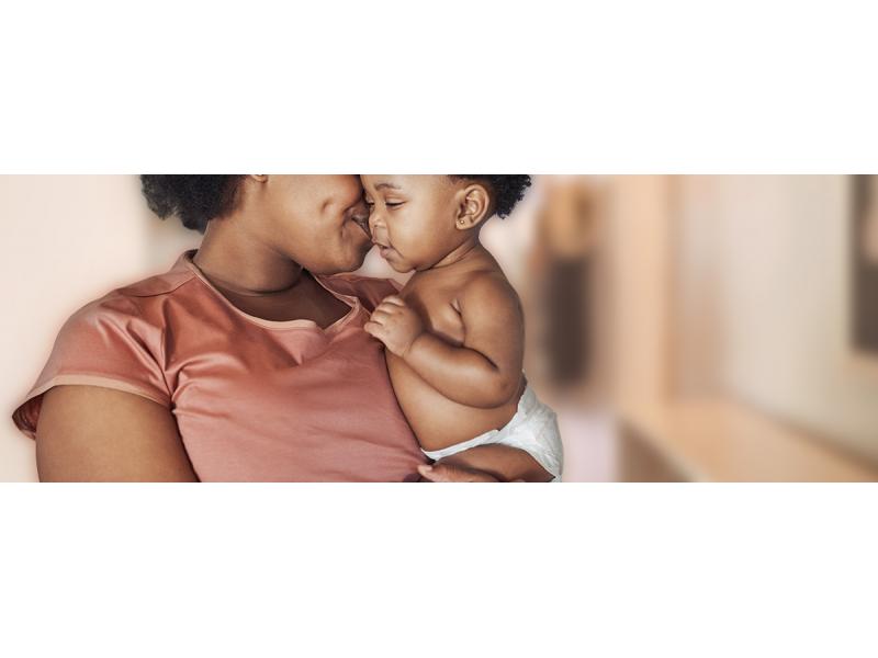 Black mother kissing his baby on the cheek