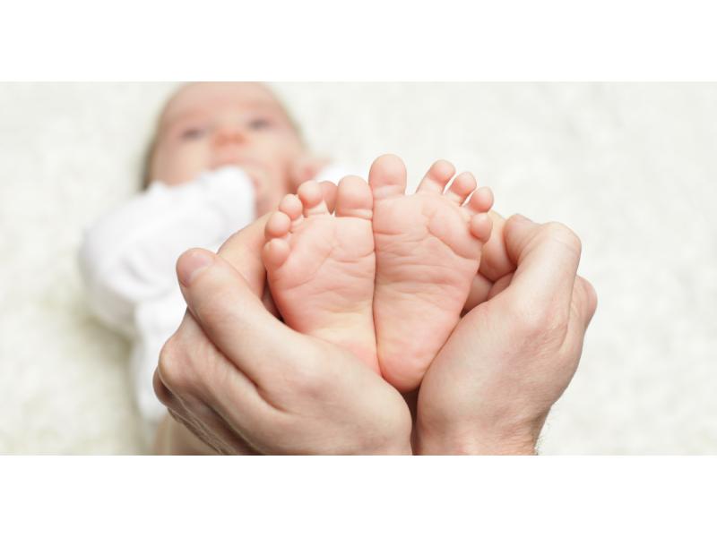 Hands holding baby's feet