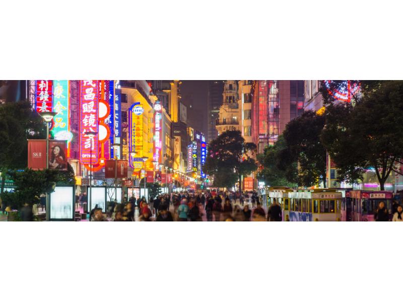 Crowded chinese street at night with neon lights