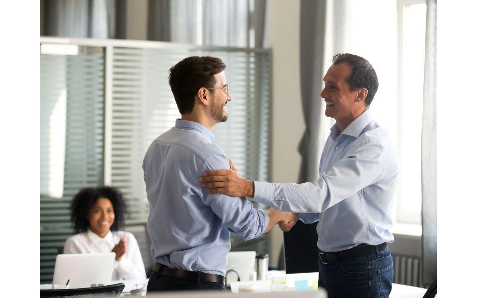 Two men shaking hands and showing respect to each other